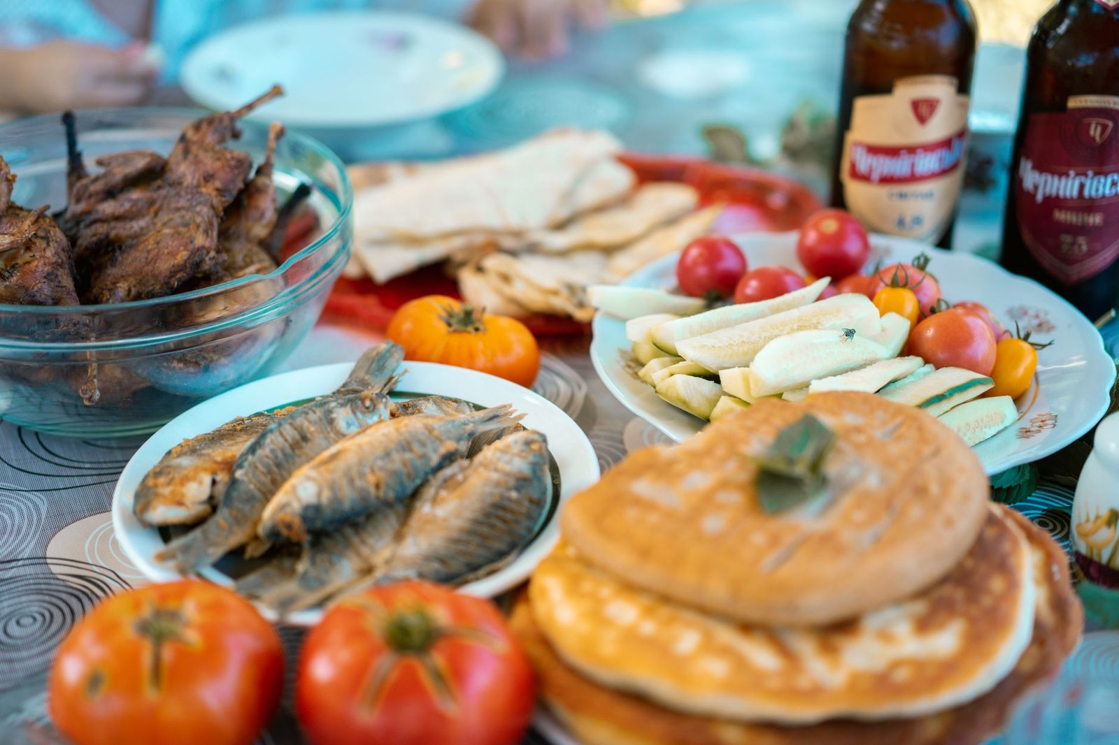 An enticing spread of grilled meats, fish, vegetables, and beer for a delicious outdoor picnic