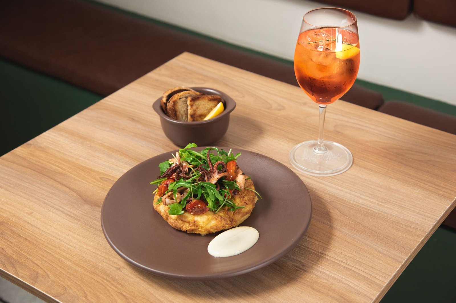 Delicious octopus dish served with Aperol spritz cocktail in a Puebla restaurant setting