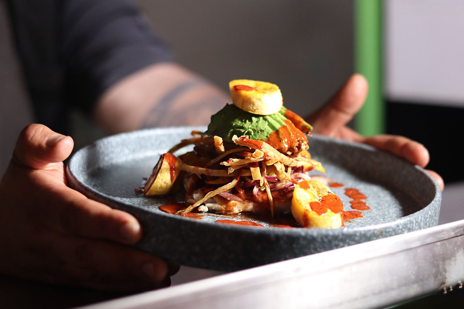 A delicious gourmet meal featuring plantains and sauce, elegantly plated and ready to serve