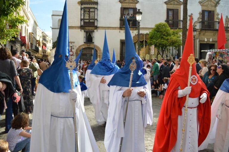 Colorful traditional procession with participants in robes and hoods in Seville, Spain