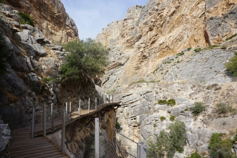 Explore the scenic rocky pathway through El Caminito del Rey, surrounded by cliffs and natural beauty