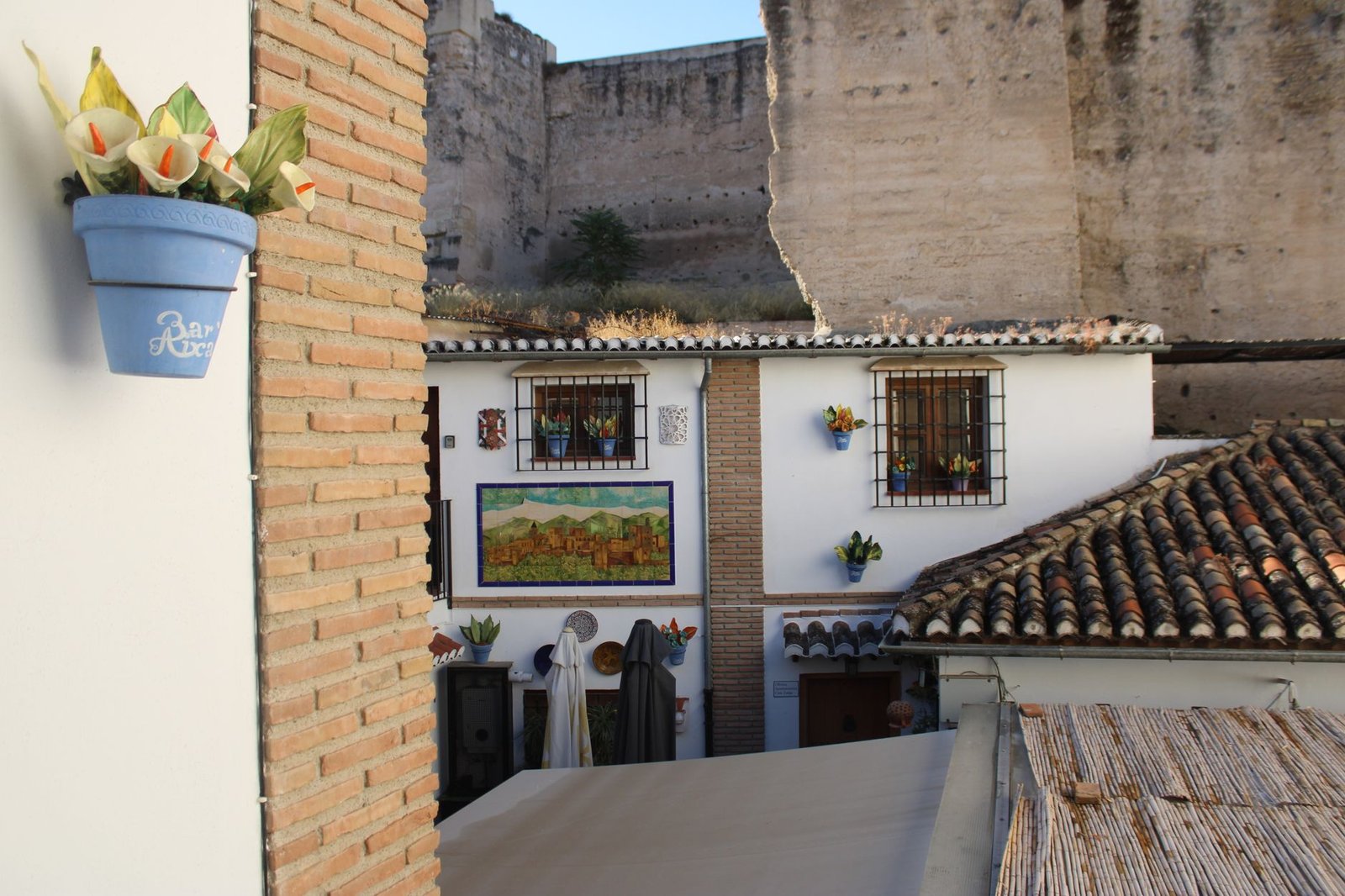 A Andalusian building adorned with colorful decorations and traditional tile work in sunny Granada