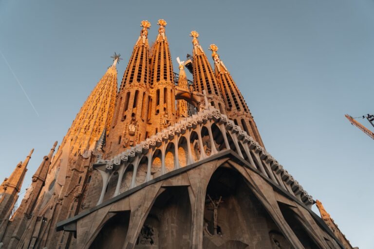view of the Sagrada Familia's intricate architecture illuminated by sunset light in Barcelona