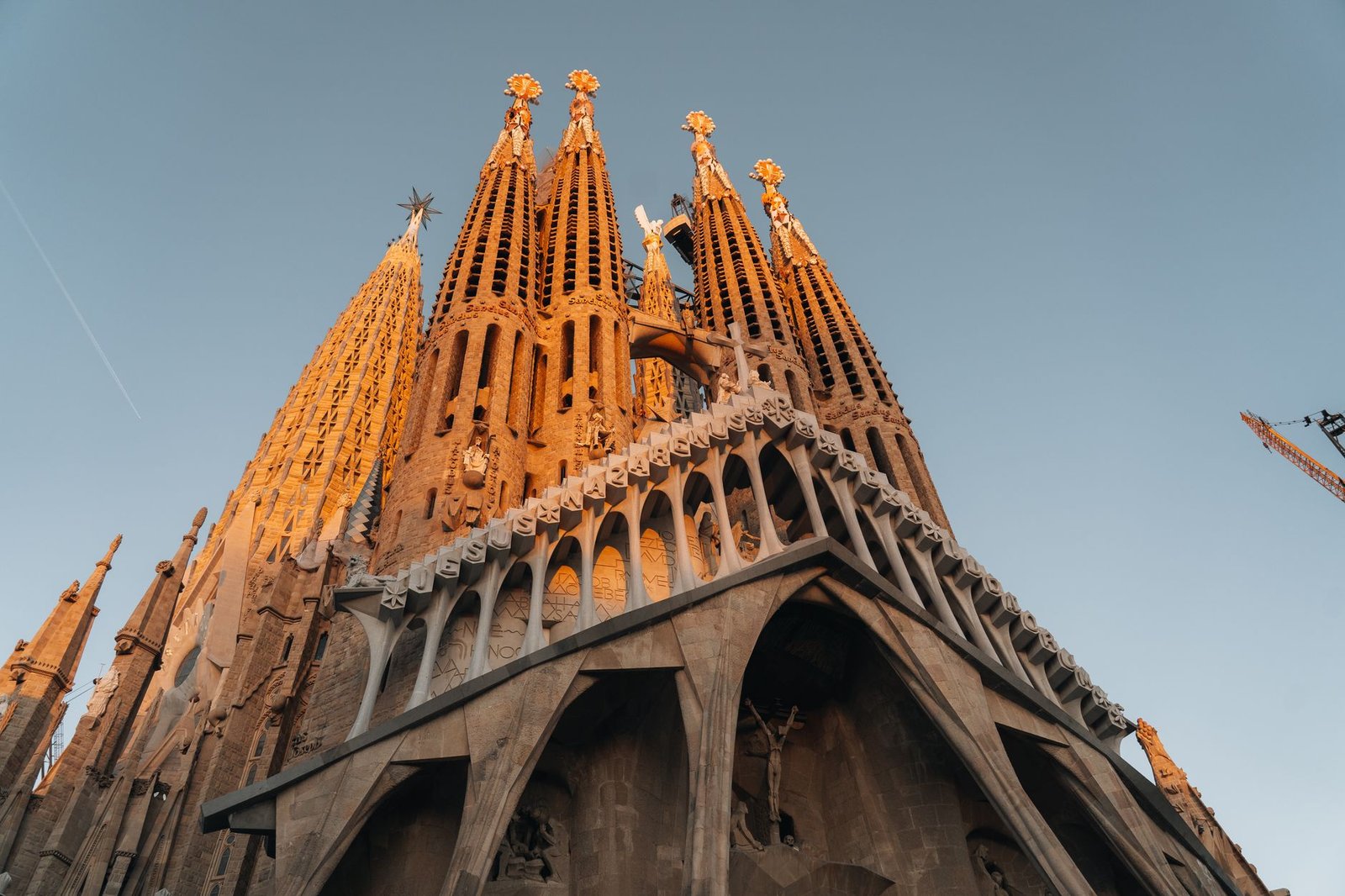 view of the Sagrada Familia's intricate architecture illuminated by sunset light in Barcelona