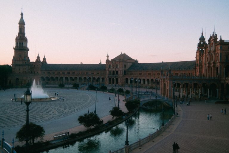 Capture of the iconic Plaza de España at twilight in Seville, showcasing its beautiful architecture and atmosphere