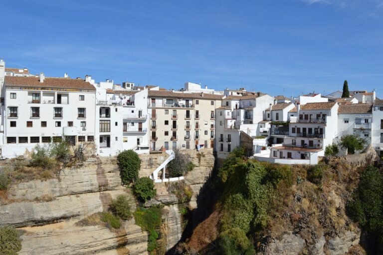 Beautiful whitewashed buildings perched on a cliff in Ronda, Andalusia, Spain. A travel destination