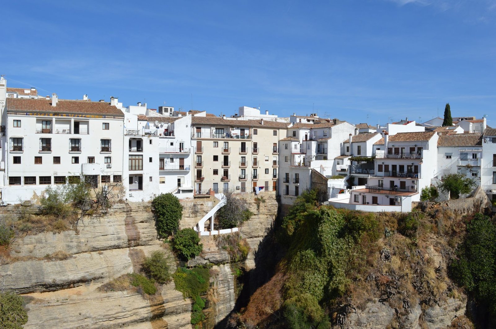 Beautiful whitewashed buildings perched on a cliff in Ronda, Andalusia, Spain. A travel destination