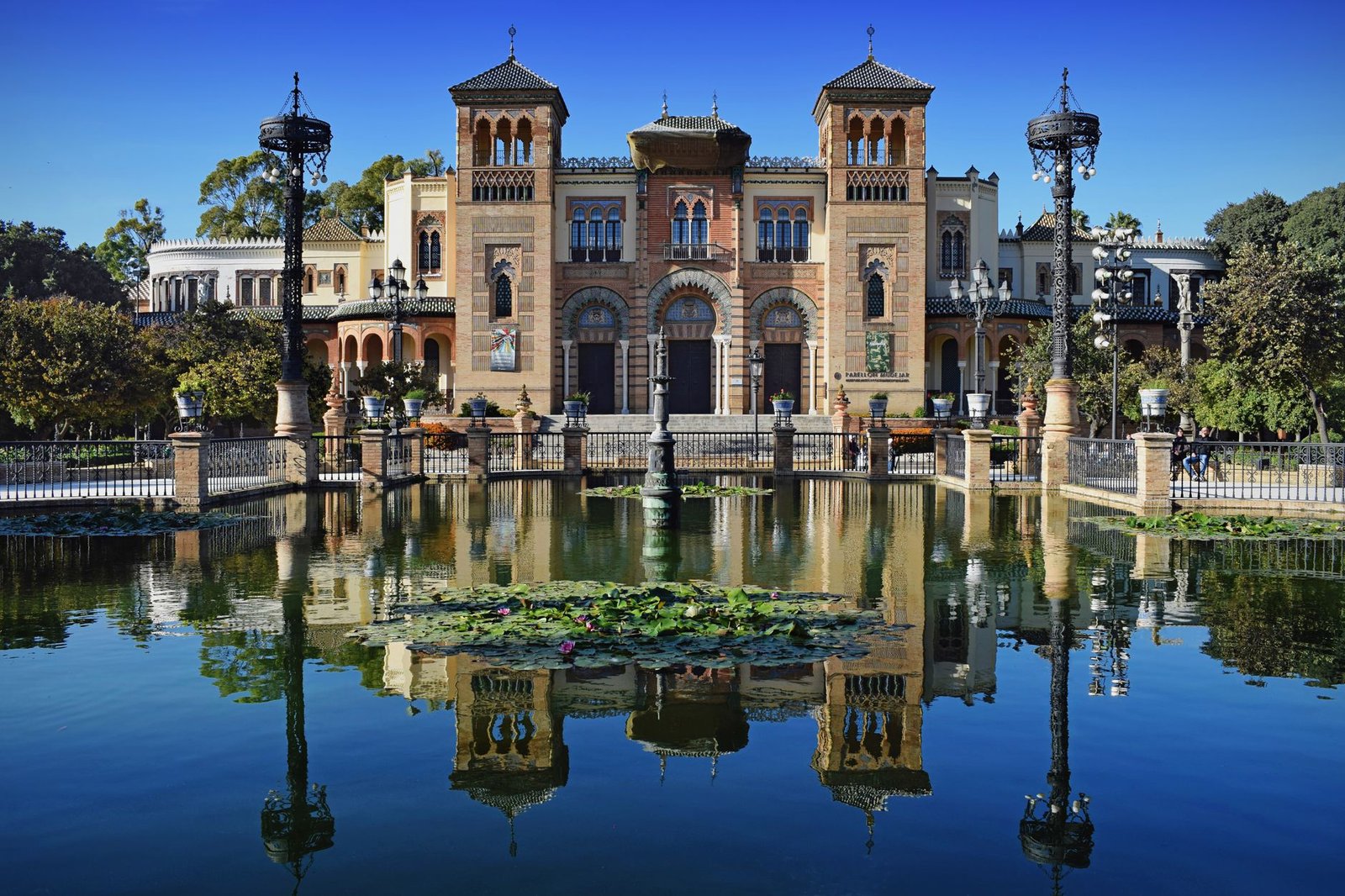 architecture reflecting in the pond at Maria Luisa Park, Seville, Spain