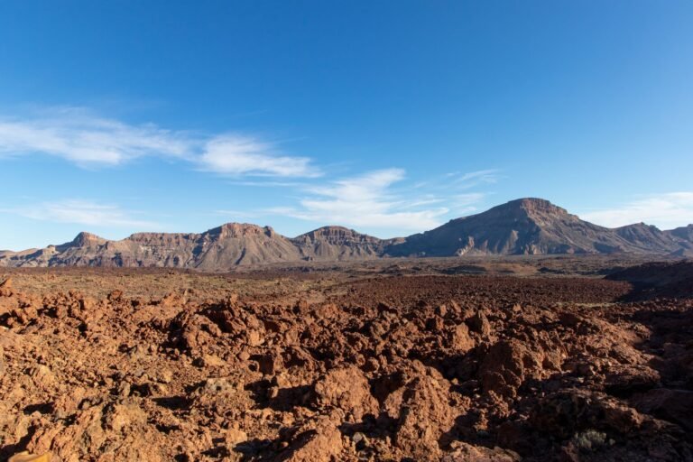 Explore the rugged, volcanic terrain of Teide National Park in Spain, captured under a clear blue sky