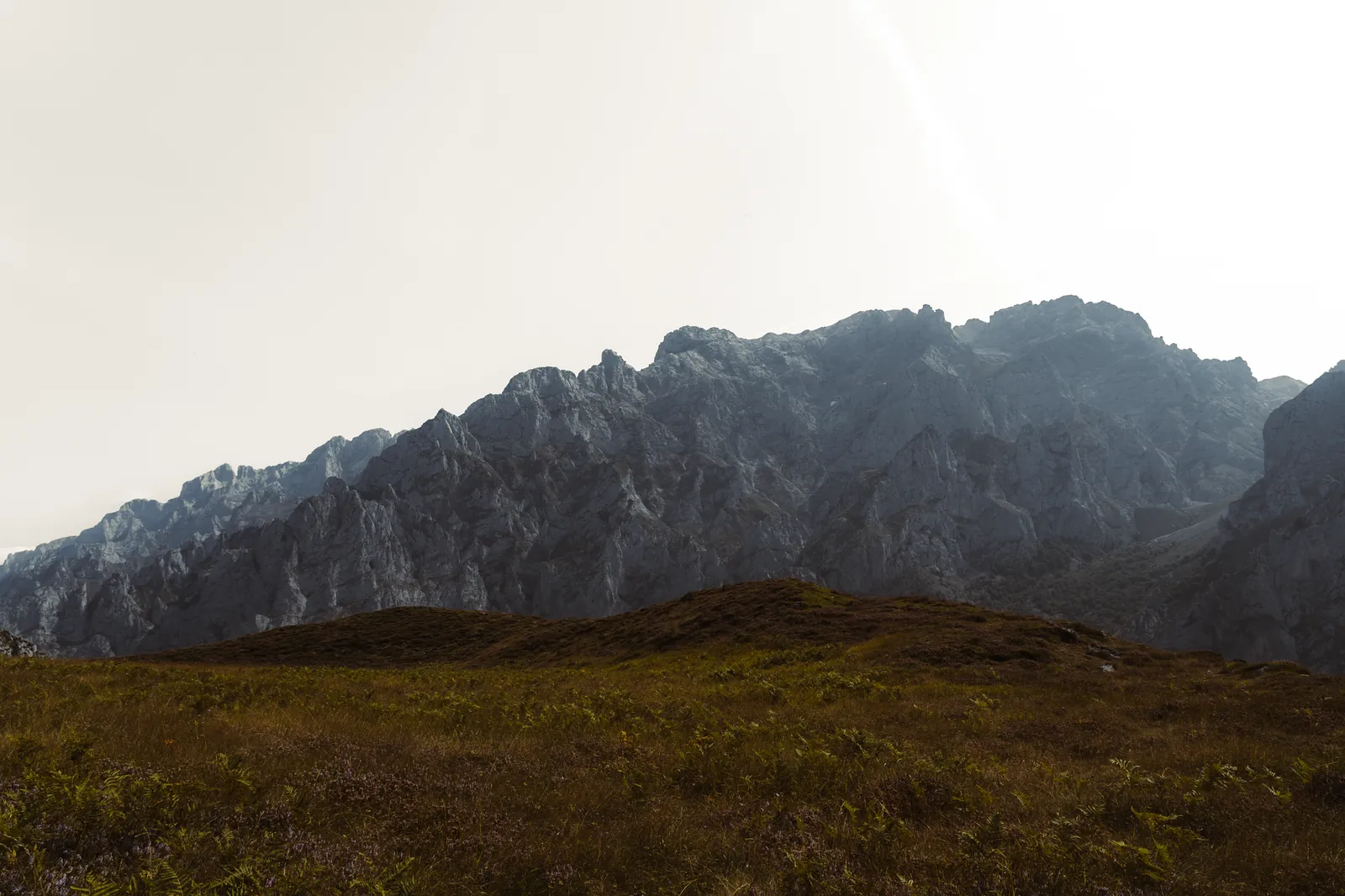 Dramatic view of Spanish mountains under a clear sky, showcasing rocky peaks and foreground