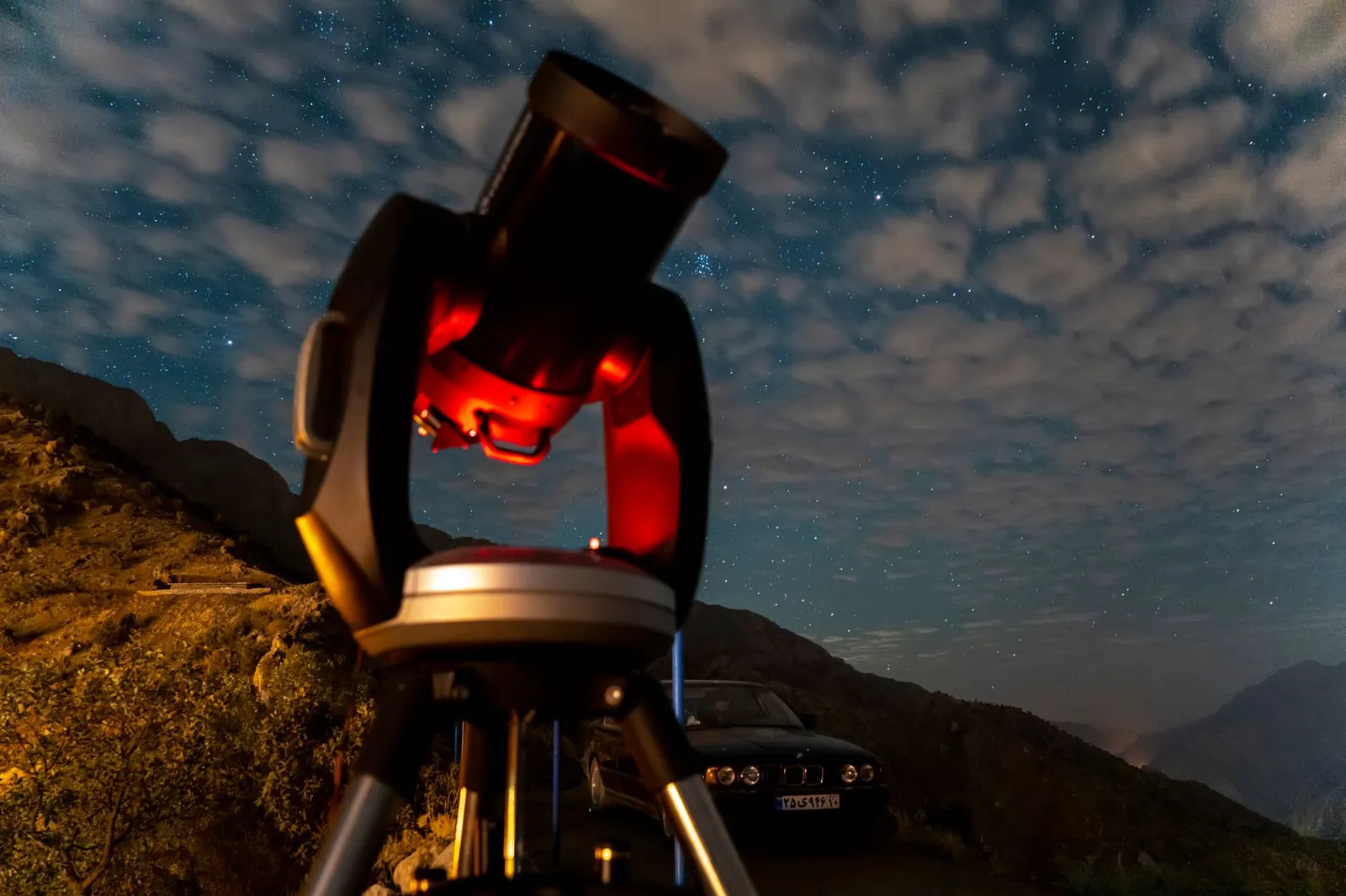 A mesmerizing view of a telescope under a starry night sky in Nodesheh, Iran