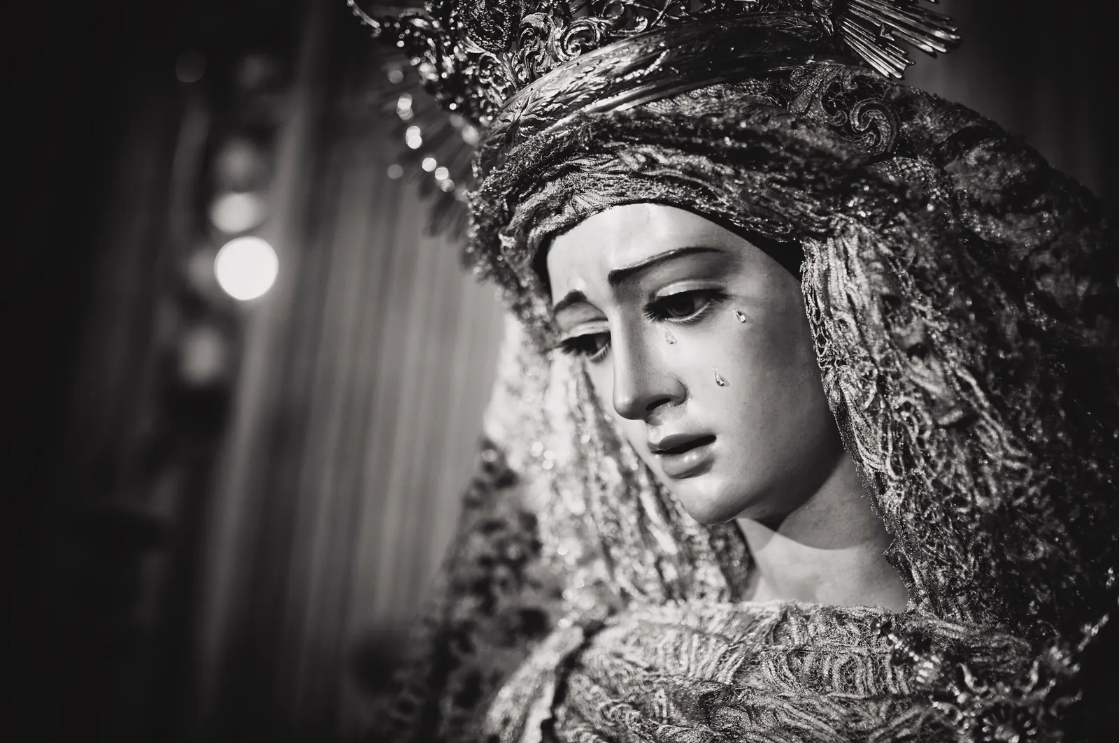 Monochrome close-up of a religious statue in Seville, Spain depicting sorrow