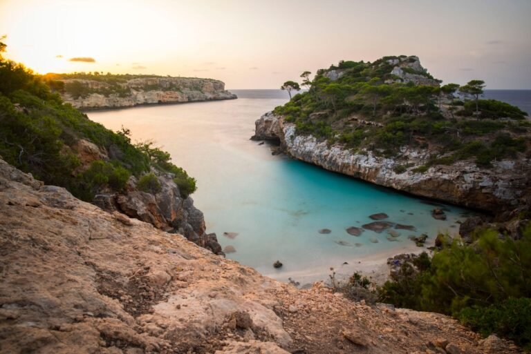 cove at sunset with turquoise waters and rocky cliffs, perfect for a tropical escape