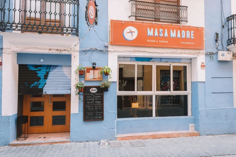 Colorful street view of Masa Madre pizza and tapas restaurant in Valencia, Spain