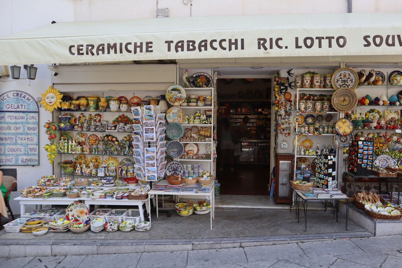 Italian souvenir shop displaying an array of colorful ceramics and local crafts