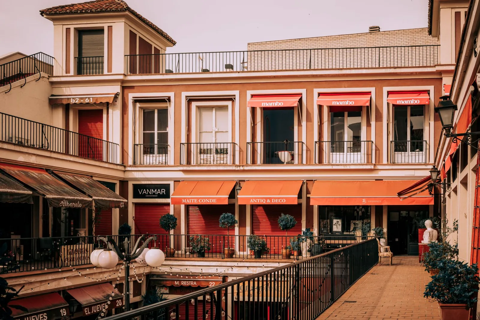 Beautiful urban courtyard in Madrid featuring awnings and local shops