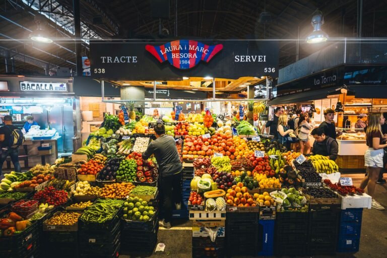 Colorful market stall displaying fresh fruits and vegetables in Barcelona's market