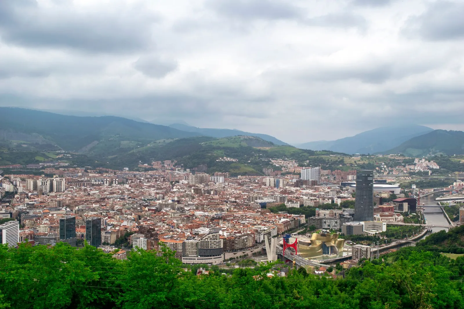 Aerial view of Bilbao, Spain featuring the Guggenheim Museum and surrounding urban landscape