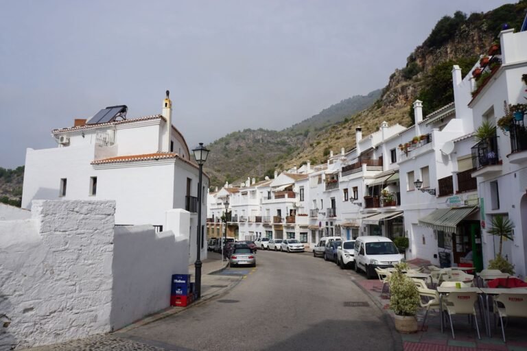 Scenic view of a whitewashed village street in southern Spain, highlighting Mediterranean architecture