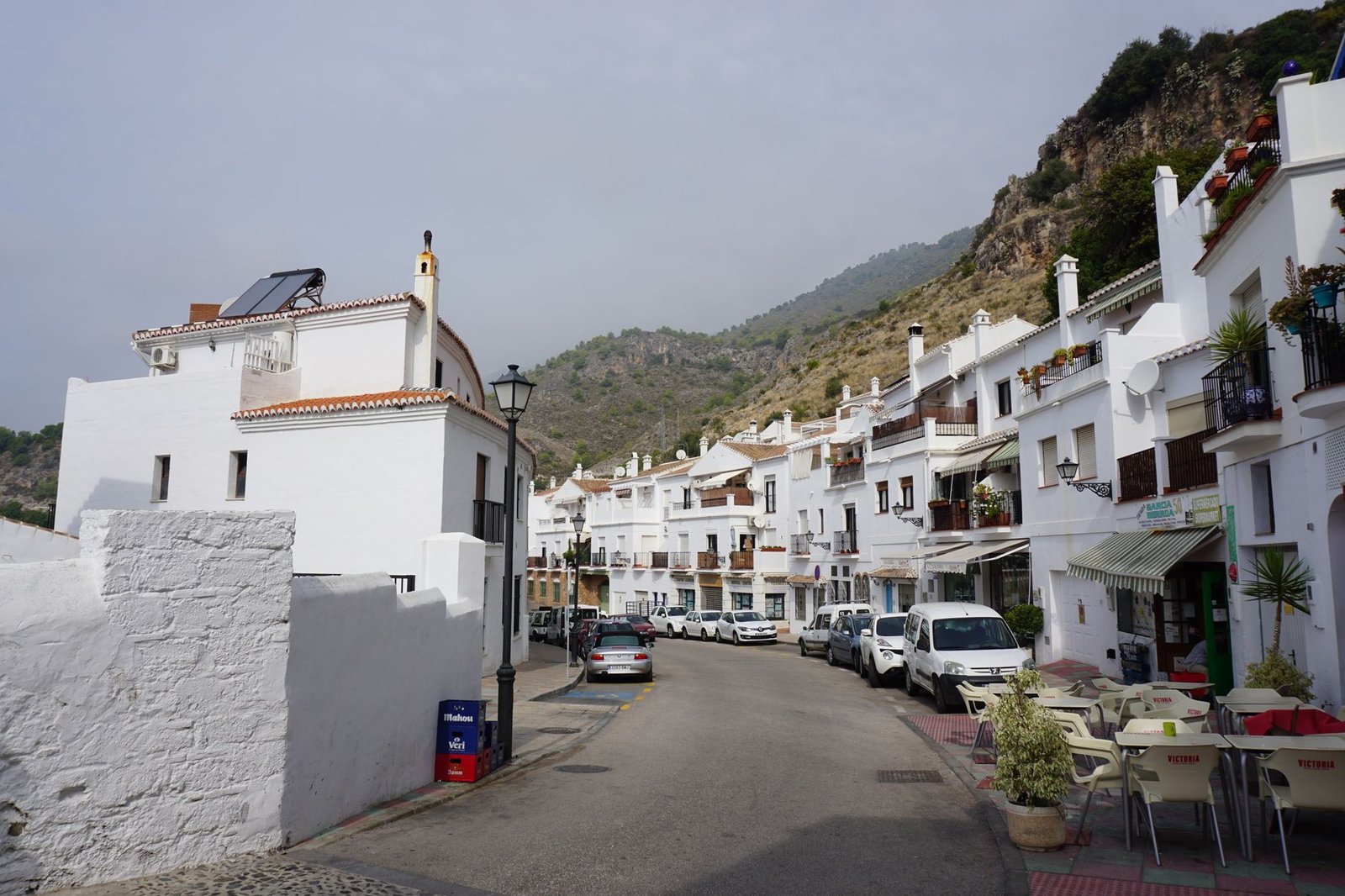 Scenic view of a whitewashed village street in southern Spain, highlighting Mediterranean architecture