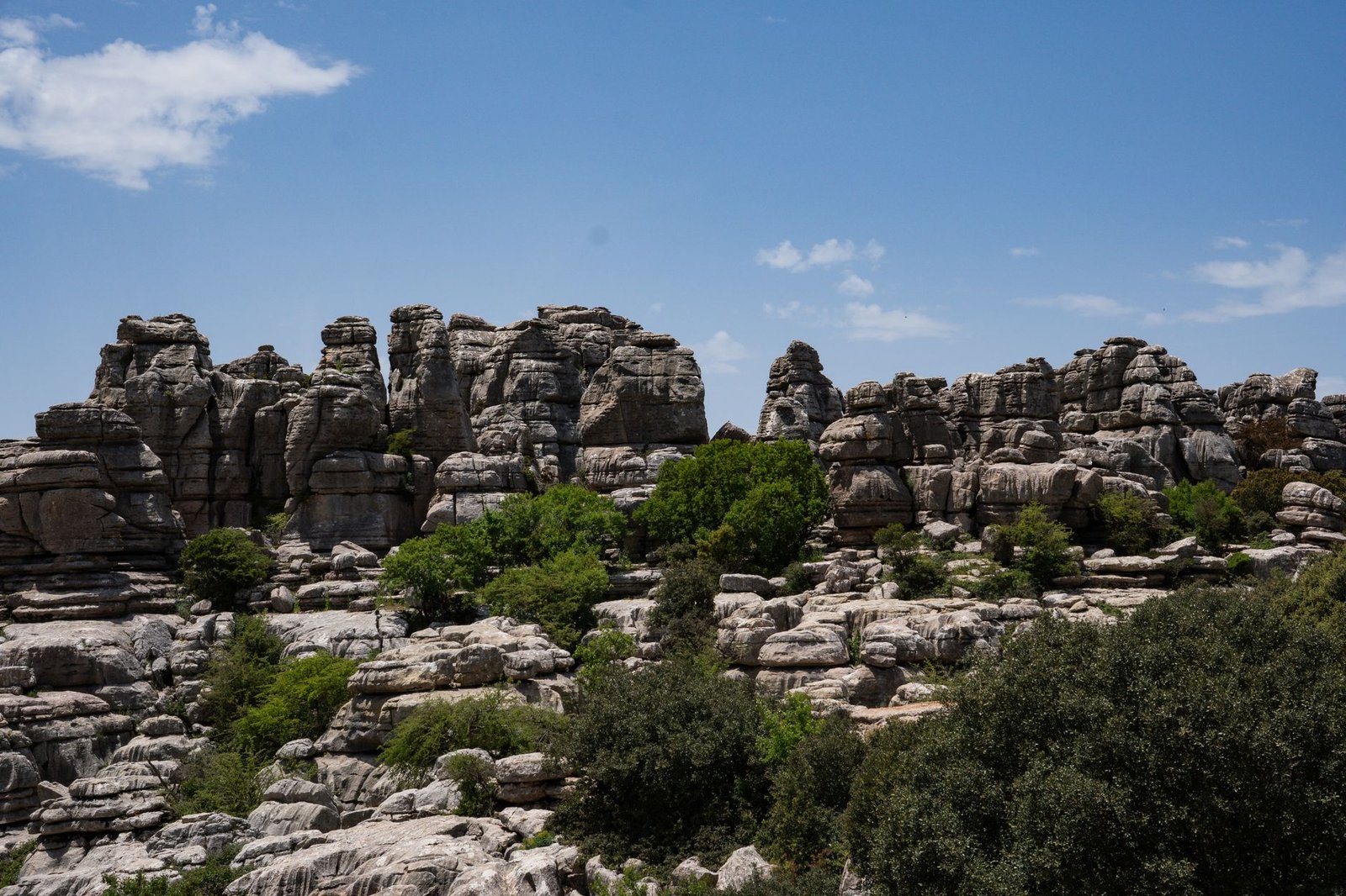 Explore the limestone rock formations in El Torcal de Antequera, Spain, under a clear blue sky