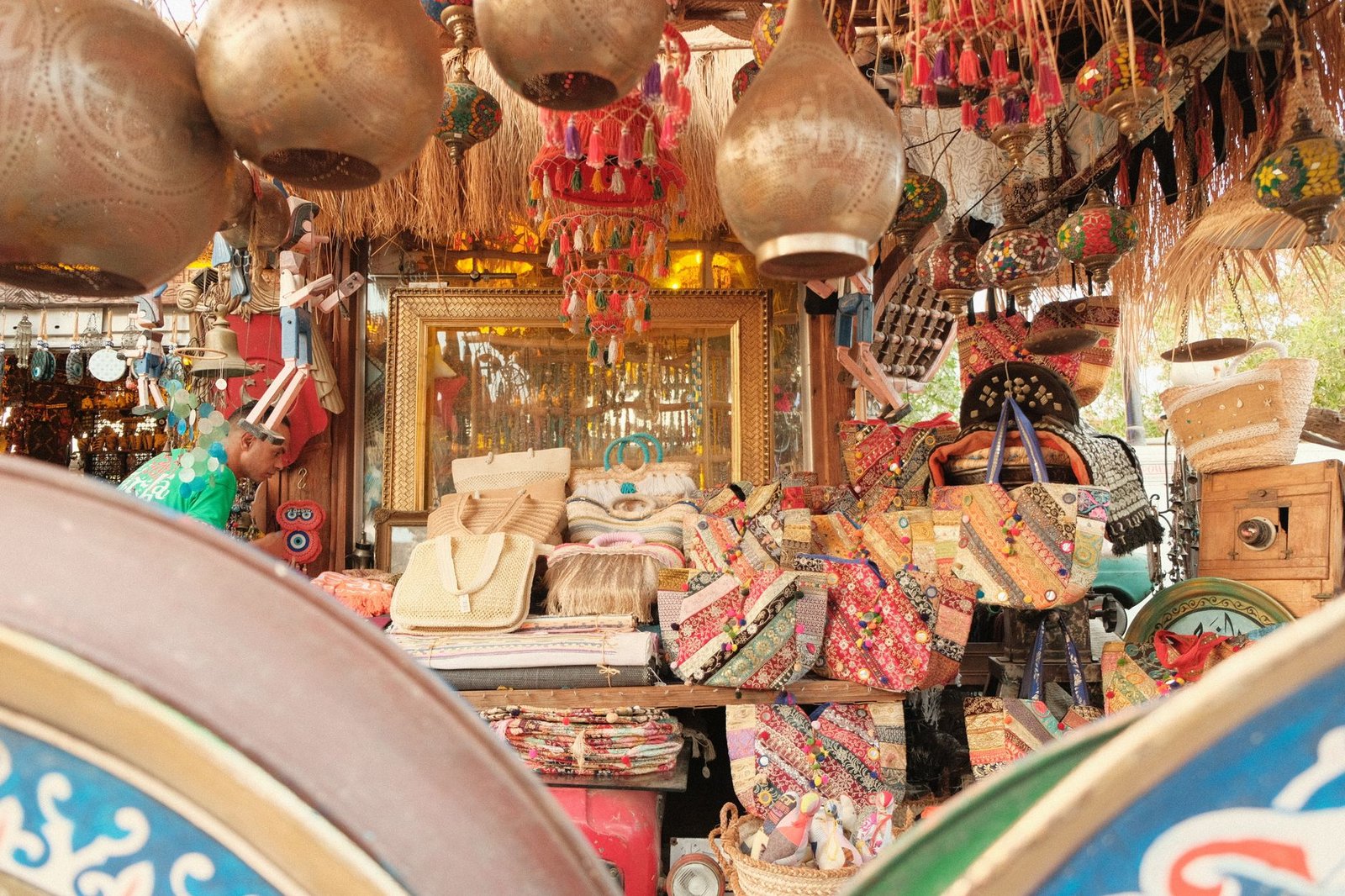 display of handcrafted bags and decor at a lively outdoor market, featuring traditional craftsmanship