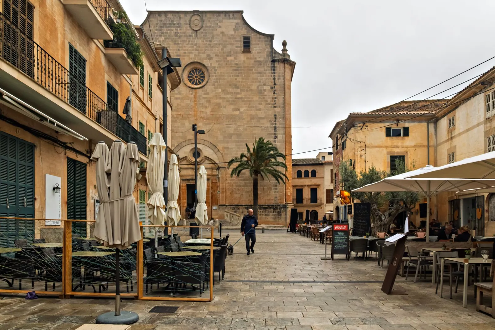 Explore a European village square featuring cafes, historic architecture, and a ambiance