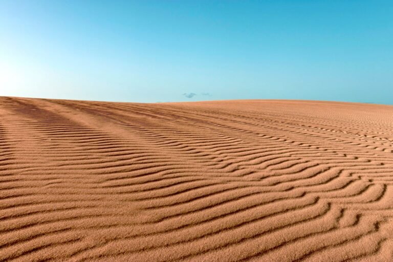 desert landscape with rippled sand dunes under a blue sky in Spain