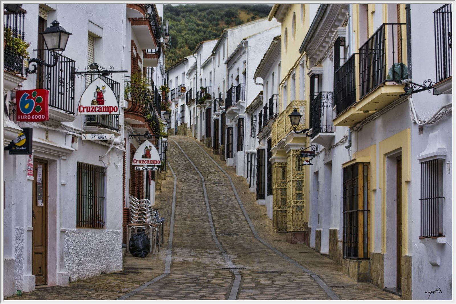 historic street view in Zahara de la Sierra, Andalusia, featuring traditional white buildings