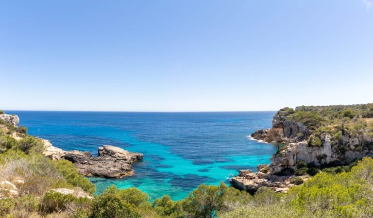 view of Sant Antoni de Portmany's turquoise sea and cliffs