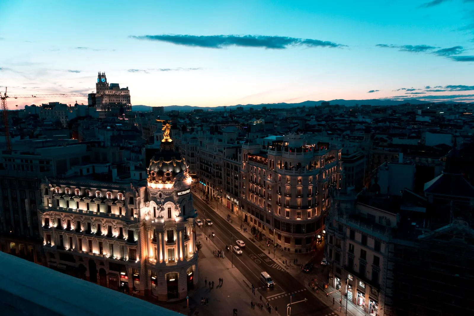 A view of Madrid cityscape during twilight with beautifully illuminated buildings and clear skies