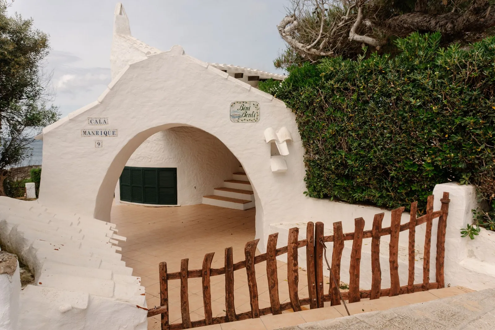 whitewashed building with archways in Ciutadella de Menorca, showcasing traditional Balearic design